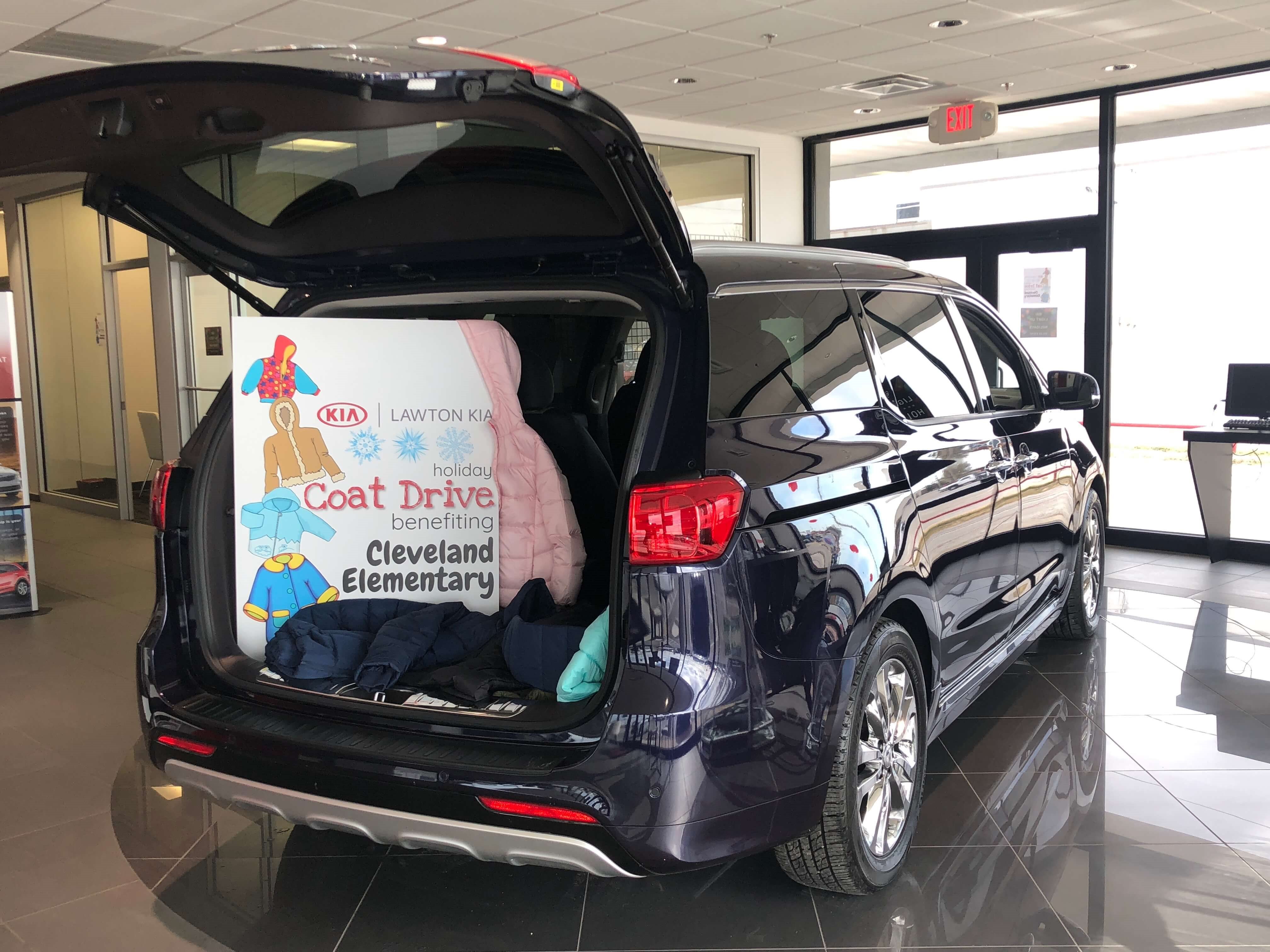 coats in the trunk of a black kia suv